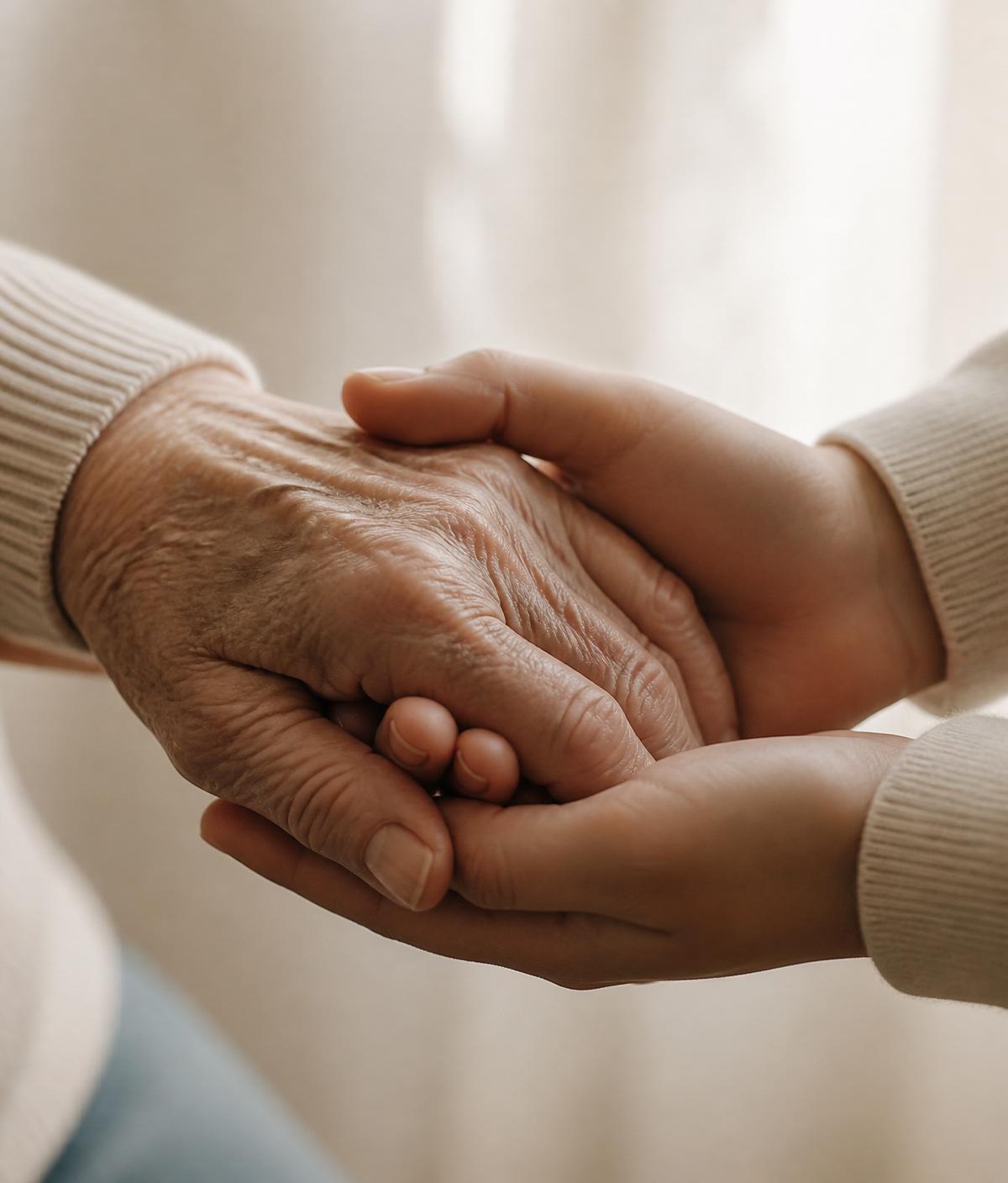 Hands of two generations gently held together